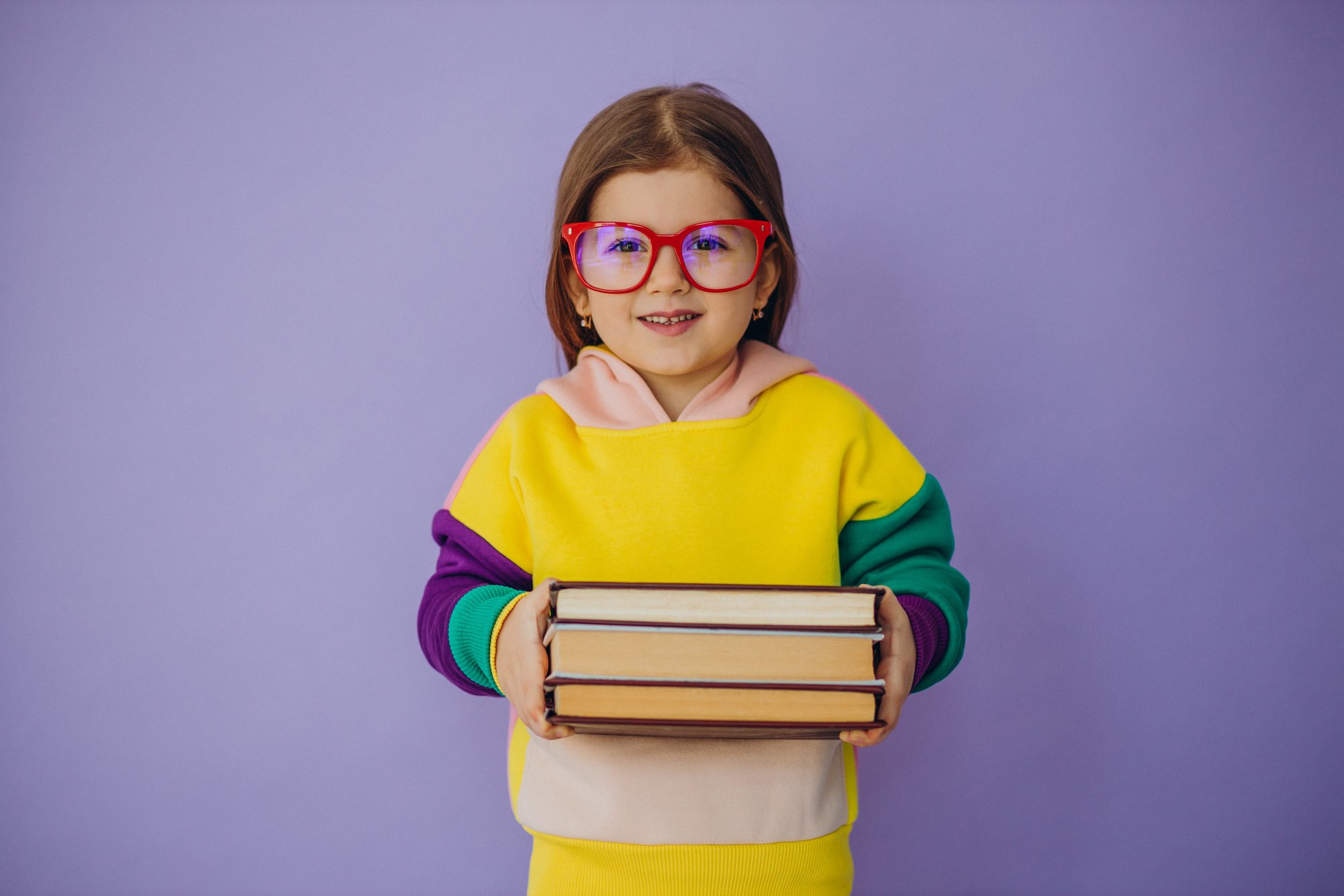 cute-little-girl-holding-books-isolated-studio